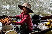 Thailand, Locals sell fruits, food and products at Damnoen Saduak floating market near Bangkok 